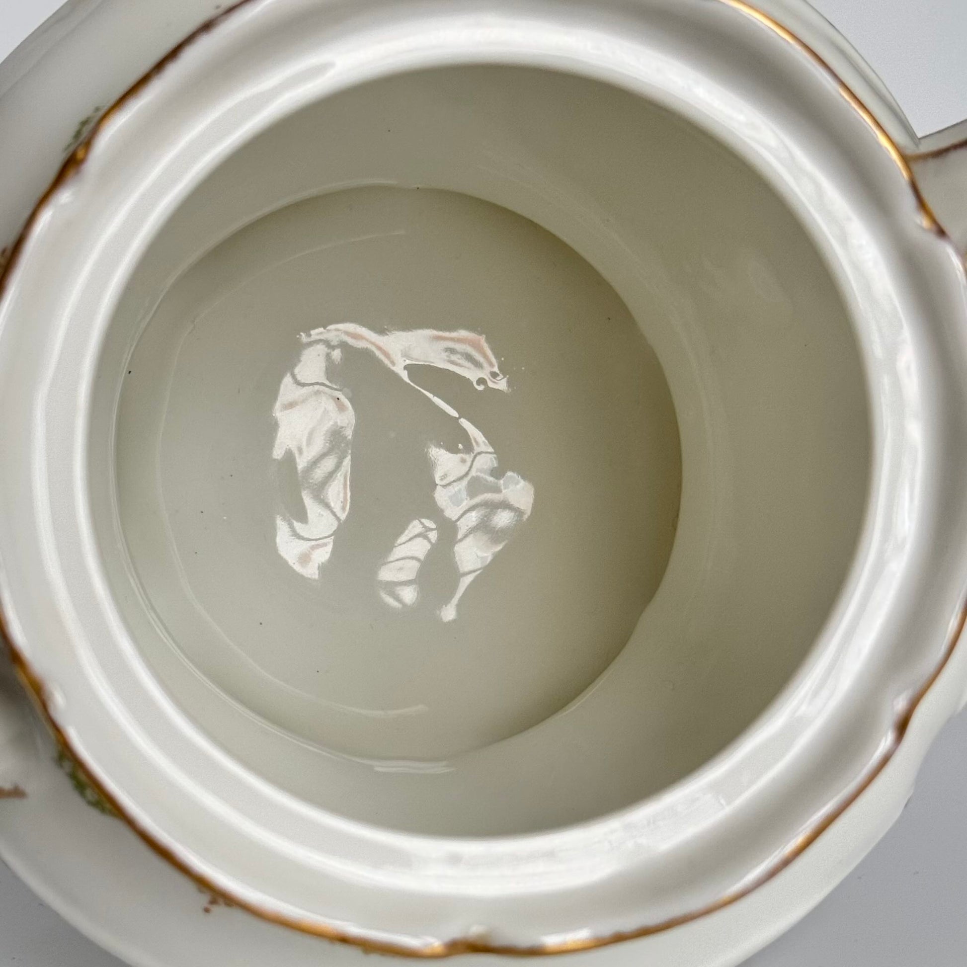 Limoges porcelain tea/coffee pot and sugar pot set with a floral and ribbon design, exuding elegance.