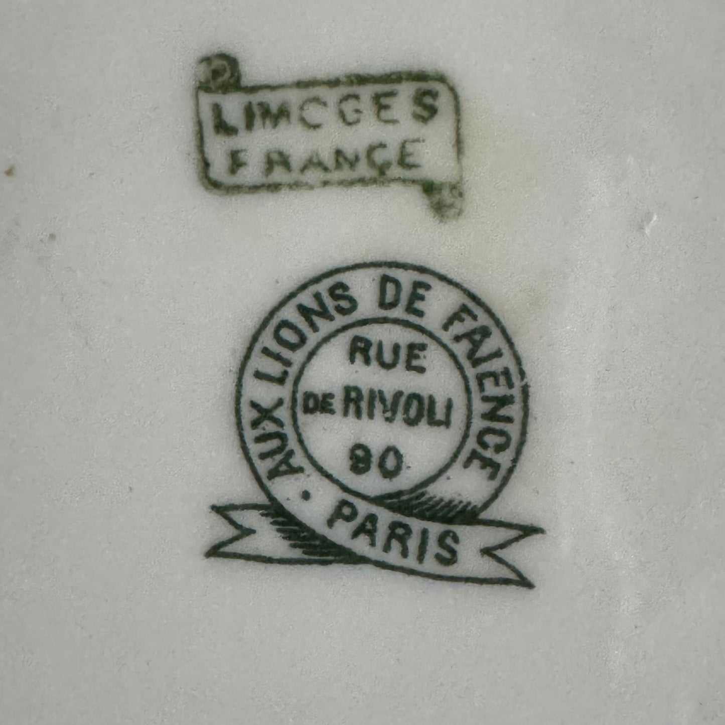 Limoges porcelain tea/coffee pot and sugar pot set with a floral and ribbon design, exuding elegance.