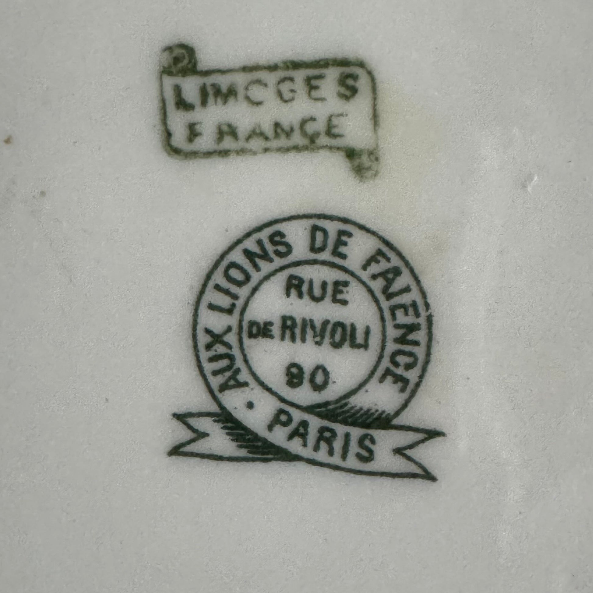 Limoges porcelain tea/coffee pot and sugar pot set with a floral and ribbon design, exuding elegance.