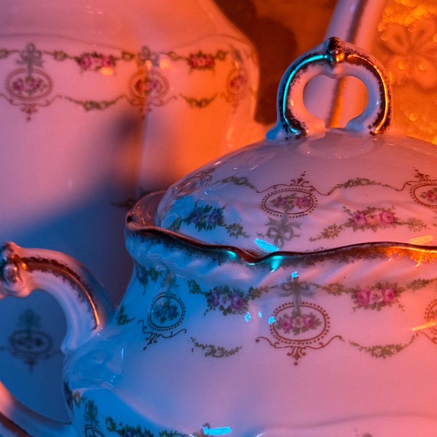Limoges porcelain tea/coffee pot and sugar pot set with a floral and ribbon design, exuding elegance.