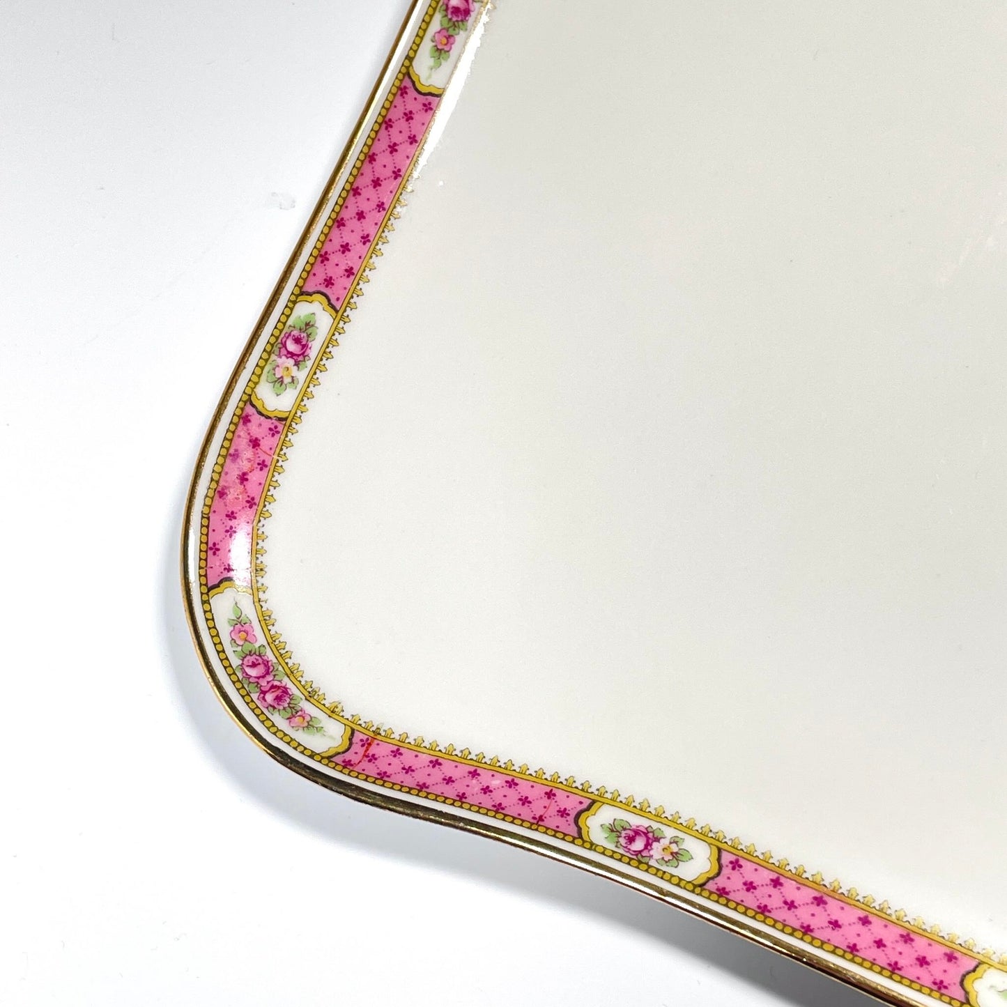 This is a Limoges porcelain tray with a delicate floral rose design and a soft pink border, perfect for tea or coffee service. It is signed by F. Paulhat Limoges, France.