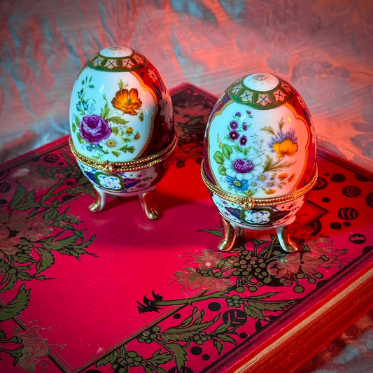 A charming set of two porcelain egg-shaped boxes with an elegant floral design. Their pretty decoration makes them perfect for storage or as decorative pieces. Vintage from the 20th century onwards.