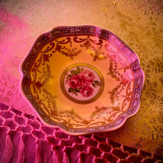 Porcelain trinket tray inspired by 18th-century Sèvres, featuring delicate roses and a golden garland, adding elegance to any room.