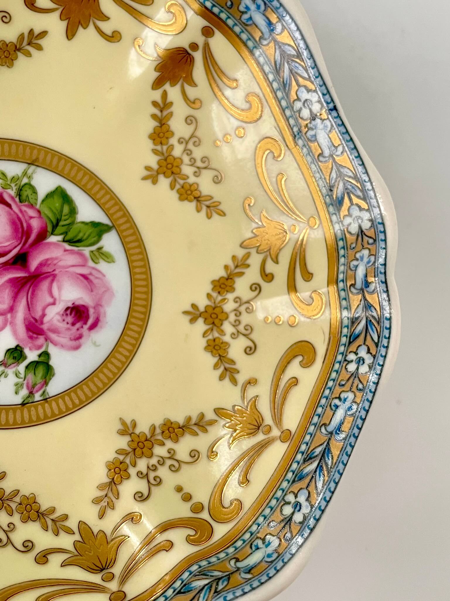 Porcelain trinket tray inspired by 18th-century Sèvres, featuring delicate roses and a golden garland, adding elegance to any room.