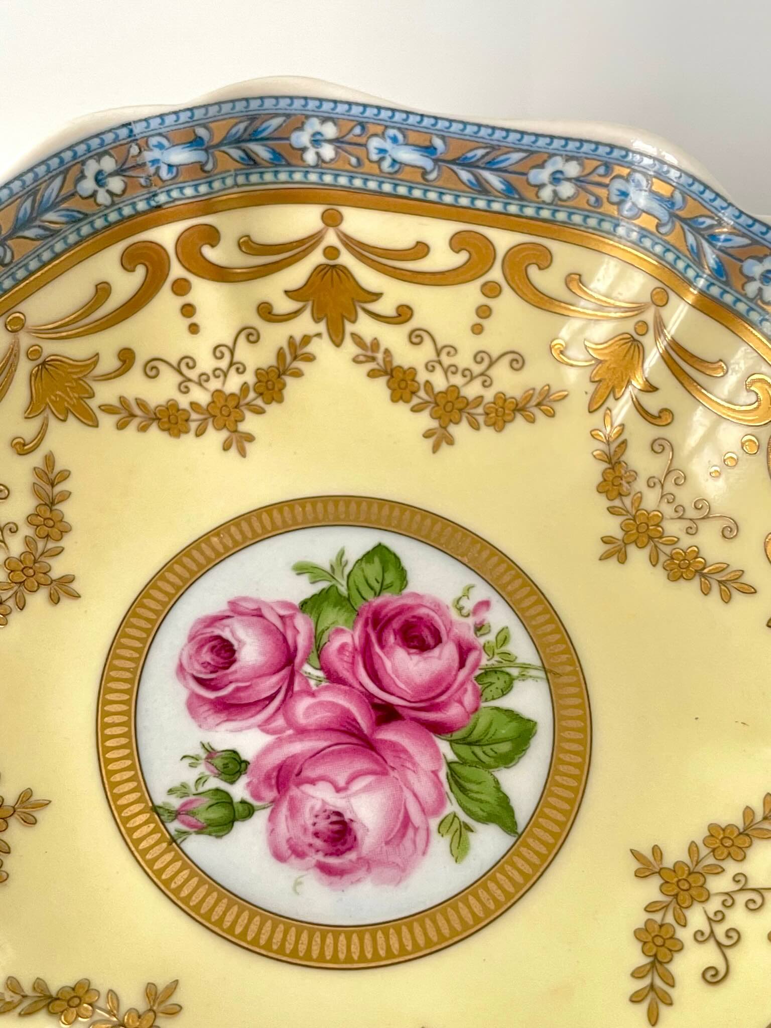 Porcelain trinket tray inspired by 18th-century Sèvres, featuring delicate roses and a golden garland, adding elegance to any room.