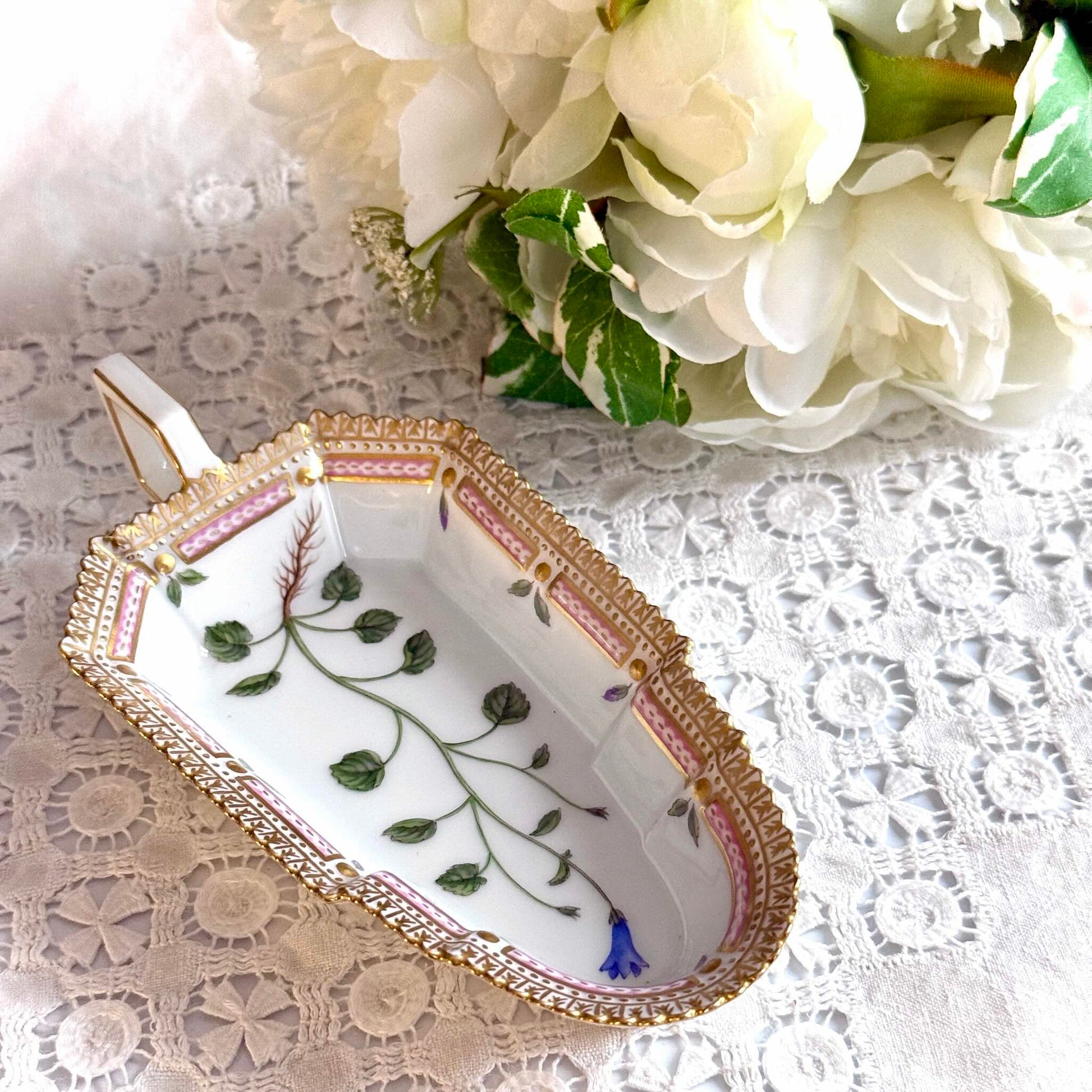 Royal Copenhagen “Flora Danica” small oblong hand-painted porcelain dish, Denmark 1967, decorated with intricate botanical illustrations inspired by 18th-century Danish scientific projects.