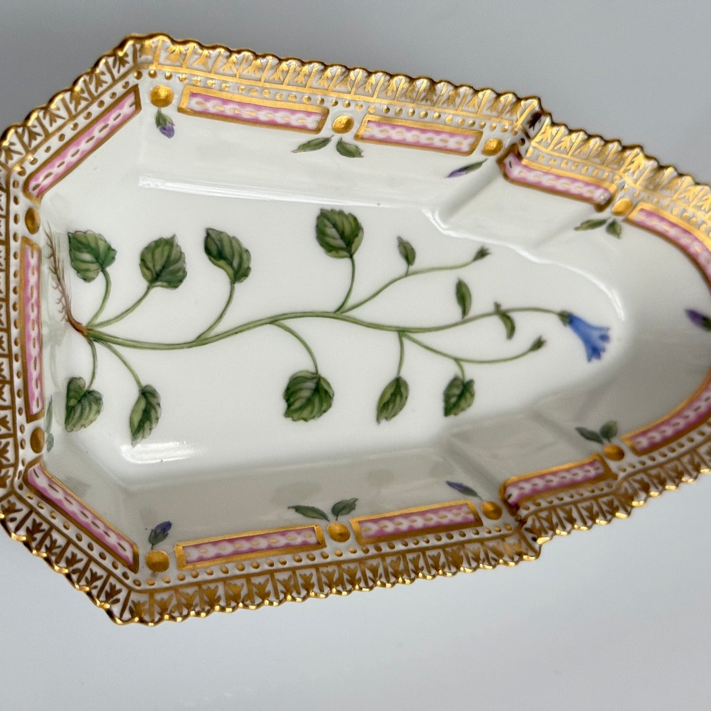 Royal Copenhagen “Flora Danica” small oblong hand-painted porcelain dish, Denmark 1967, decorated with intricate botanical illustrations inspired by 18th-century Danish scientific projects.