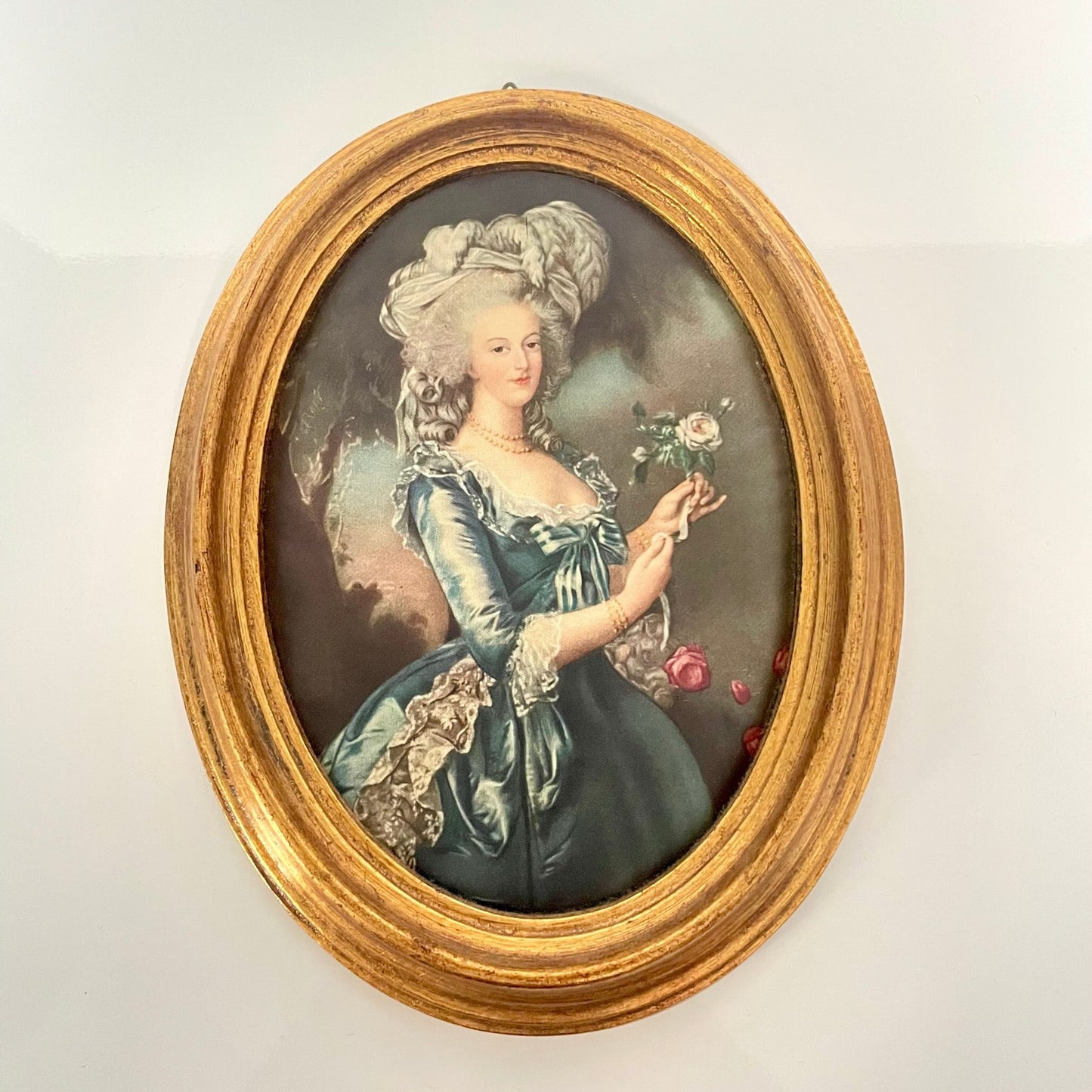 Silk print portrait of Marie Antoinette, inspired by Élisabeth Louise Vigée Le Brun's famous painting, with a rose in hand, framed in gilded wood.