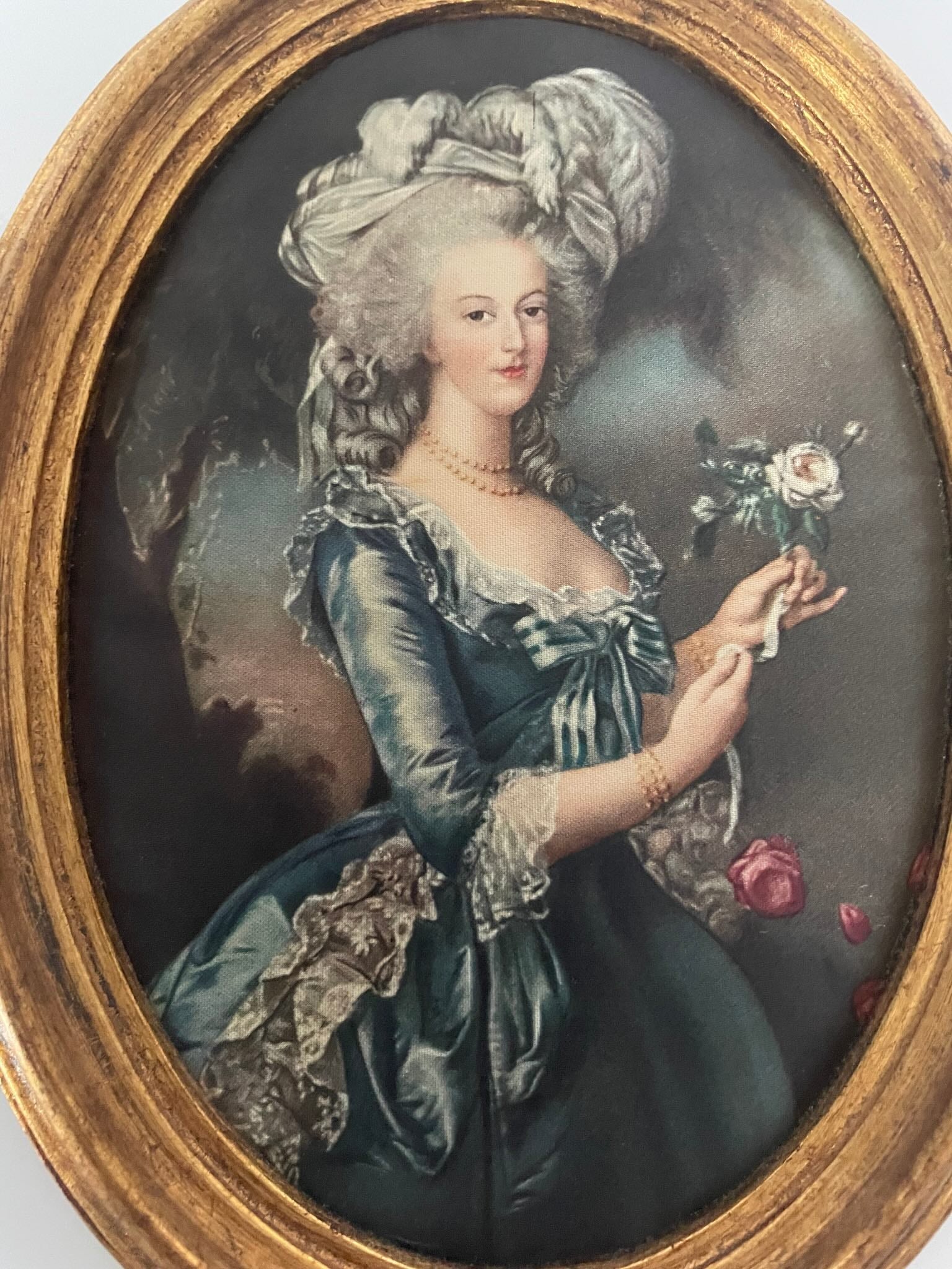Silk print portrait of Marie Antoinette, inspired by Élisabeth Louise Vigée Le Brun's famous painting, with a rose in hand, framed in gilded wood.