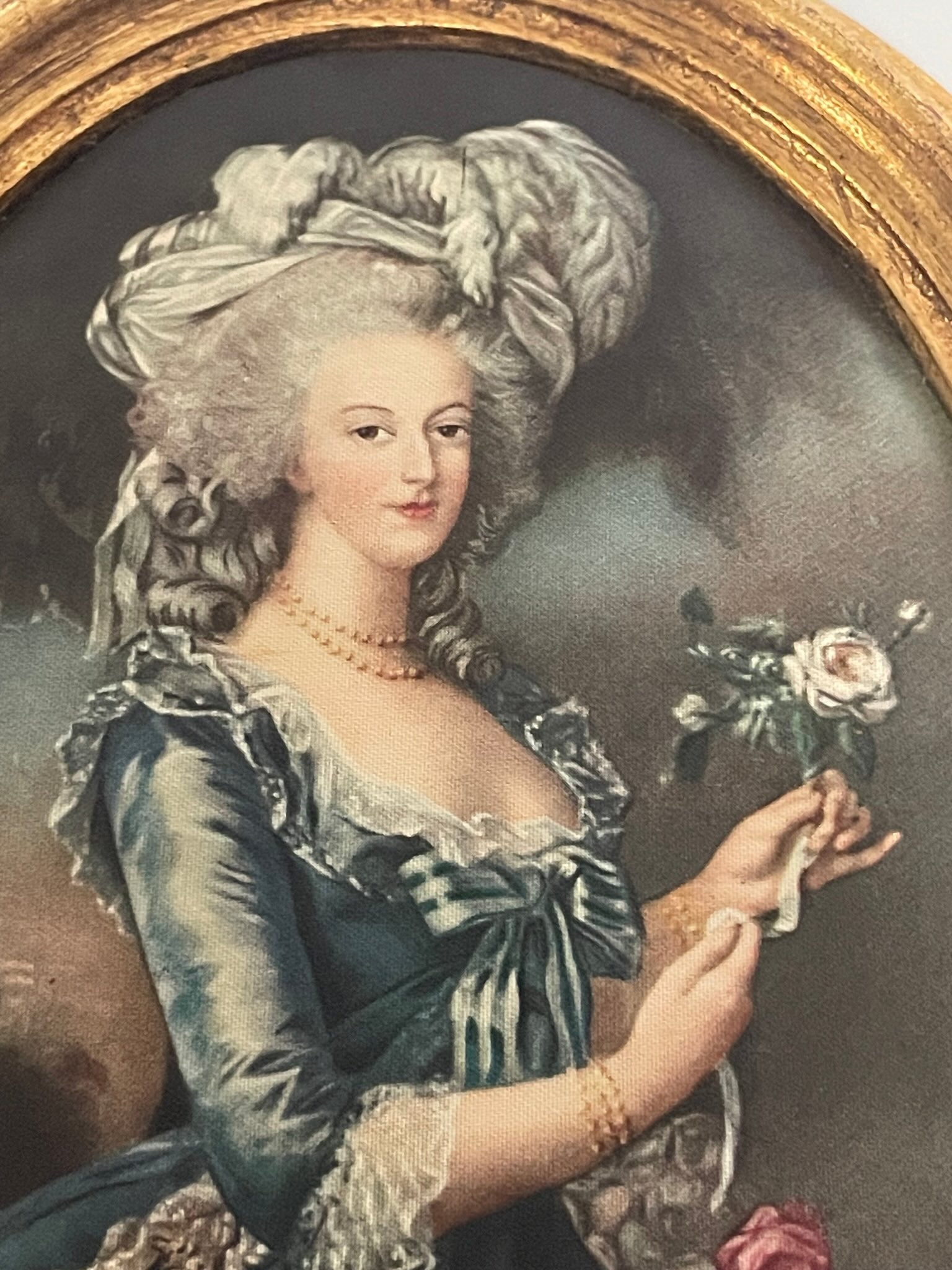 Silk print portrait of Marie Antoinette, inspired by Élisabeth Louise Vigée Le Brun's famous painting, with a rose in hand, framed in gilded wood.