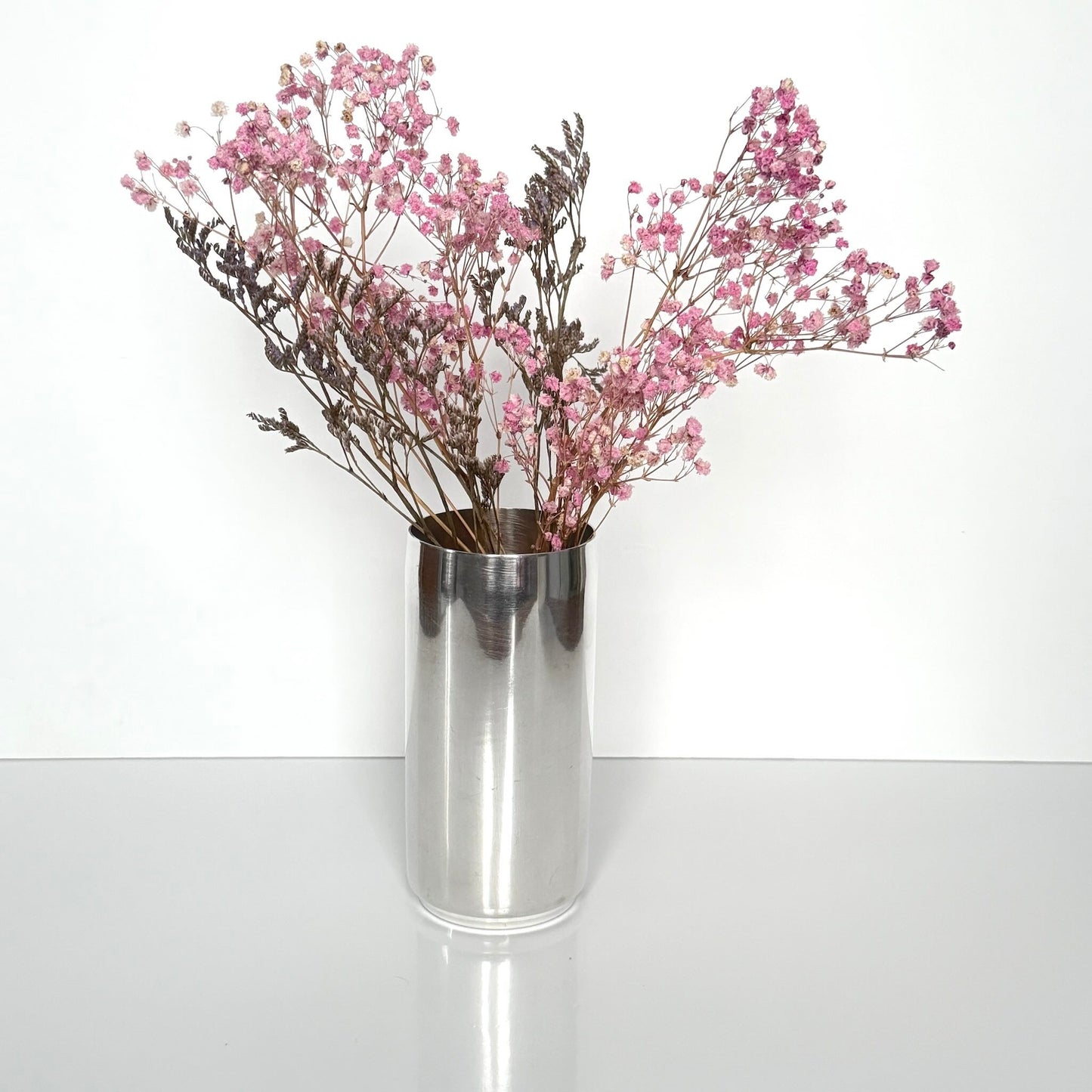 Vintage Christian Dior silver-plated tube vase, minimalist cylinder design, 20th-century French luxury decor.