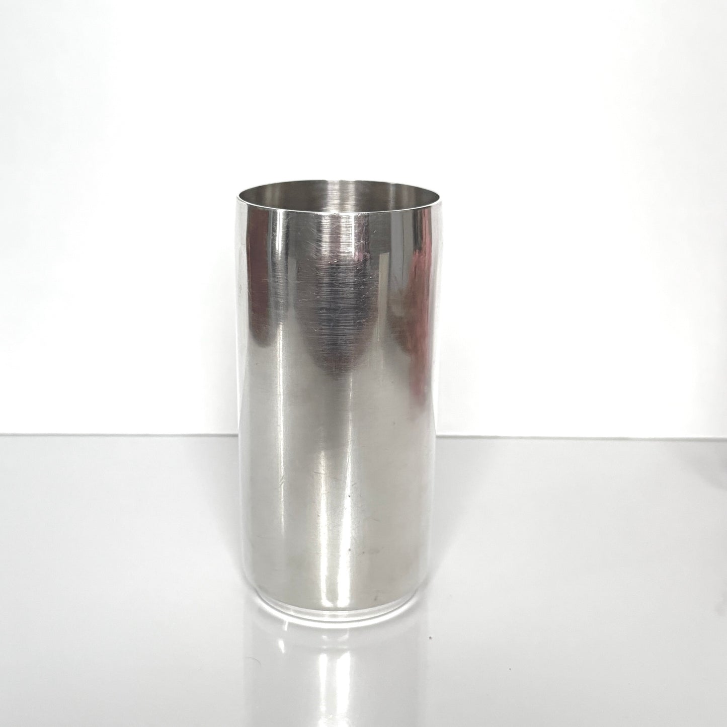 Vintage Christian Dior silver-plated tube vase, minimalist cylinder design, 20th-century French luxury decor.