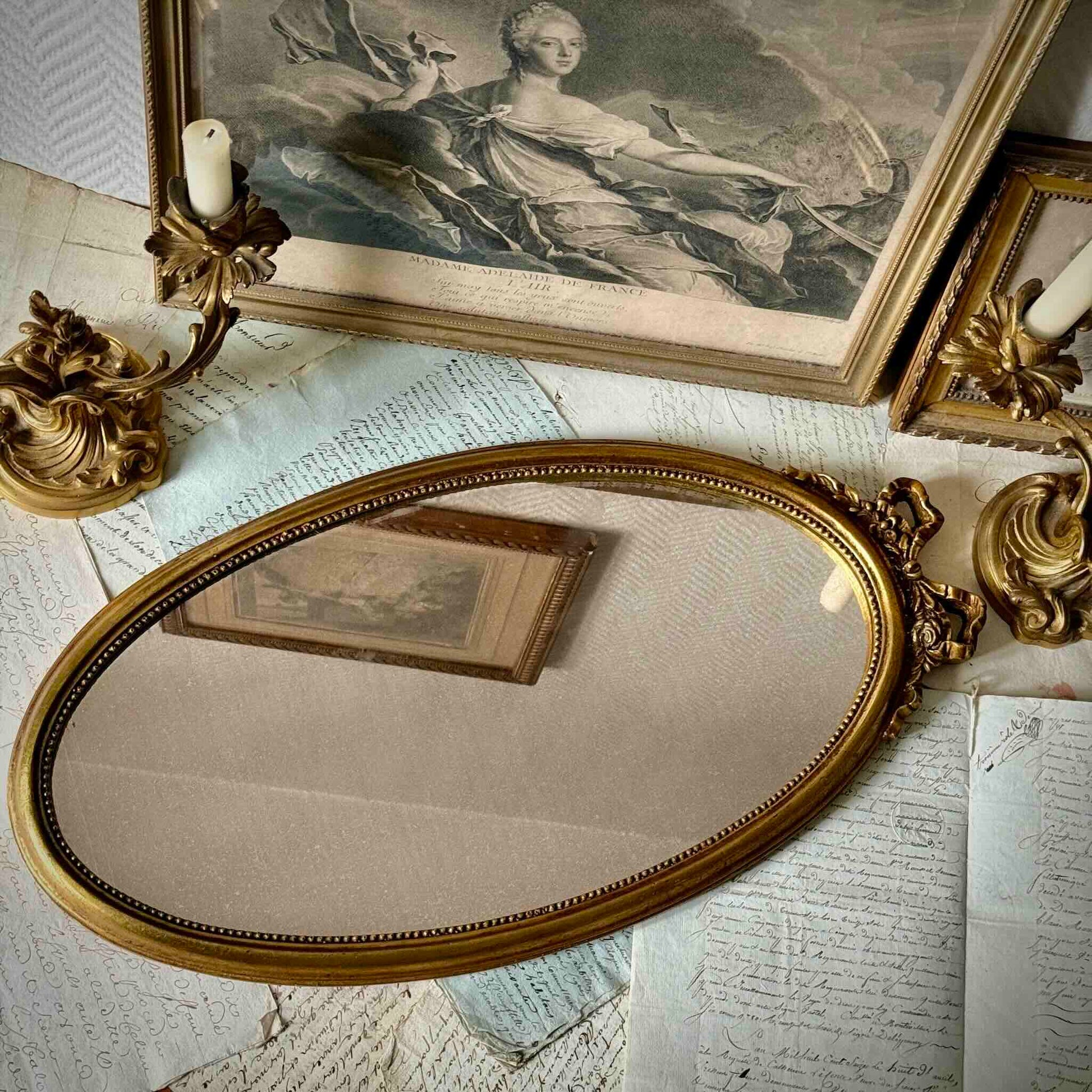 Vintage Louis XVI style gilded oval mirror, ribbon and rose crest, pearl border, 20th century France.