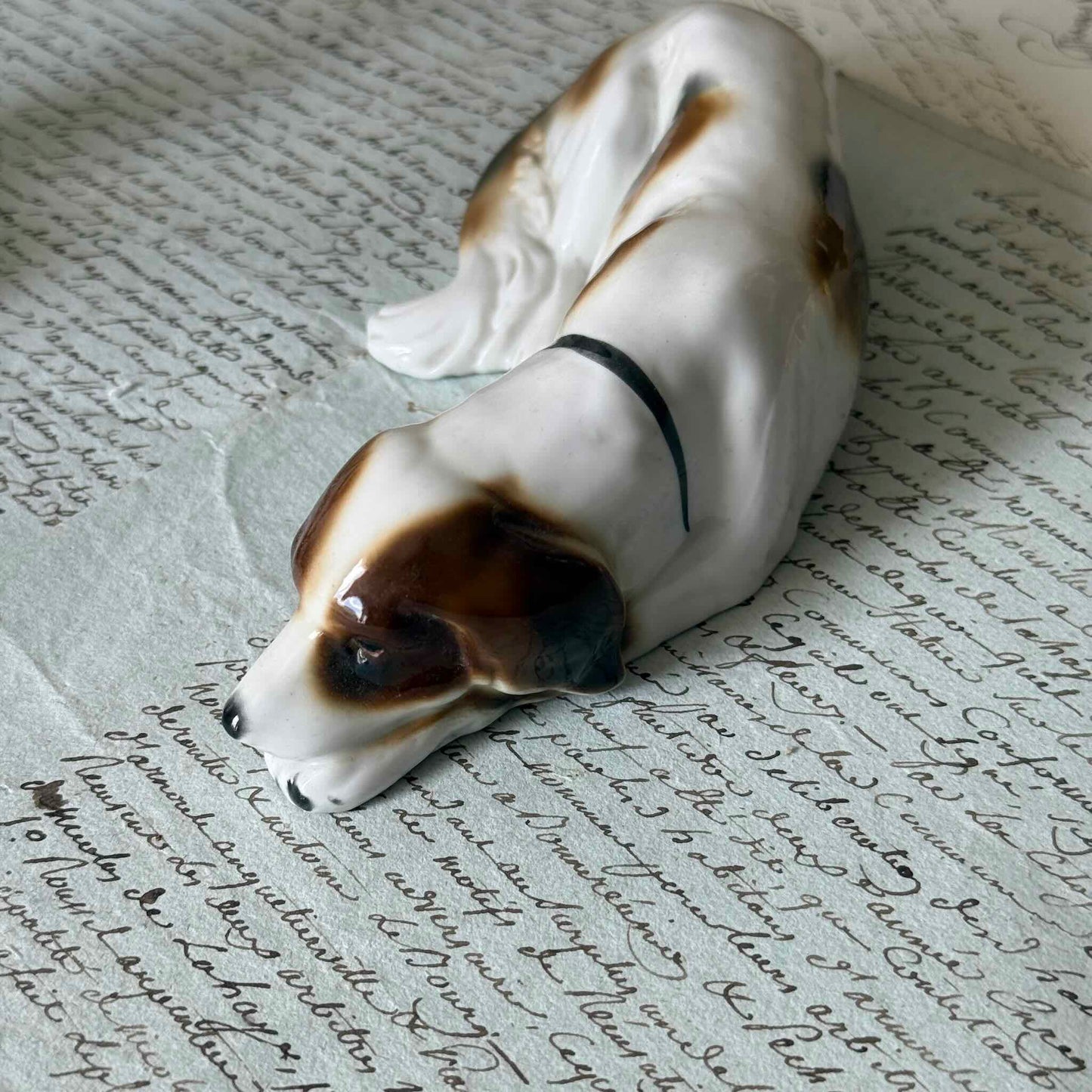 Vintage Goebel porcelain figurine of a sleeping hunting dog, hand-painted brown and white coat, circa 1935 Germany.