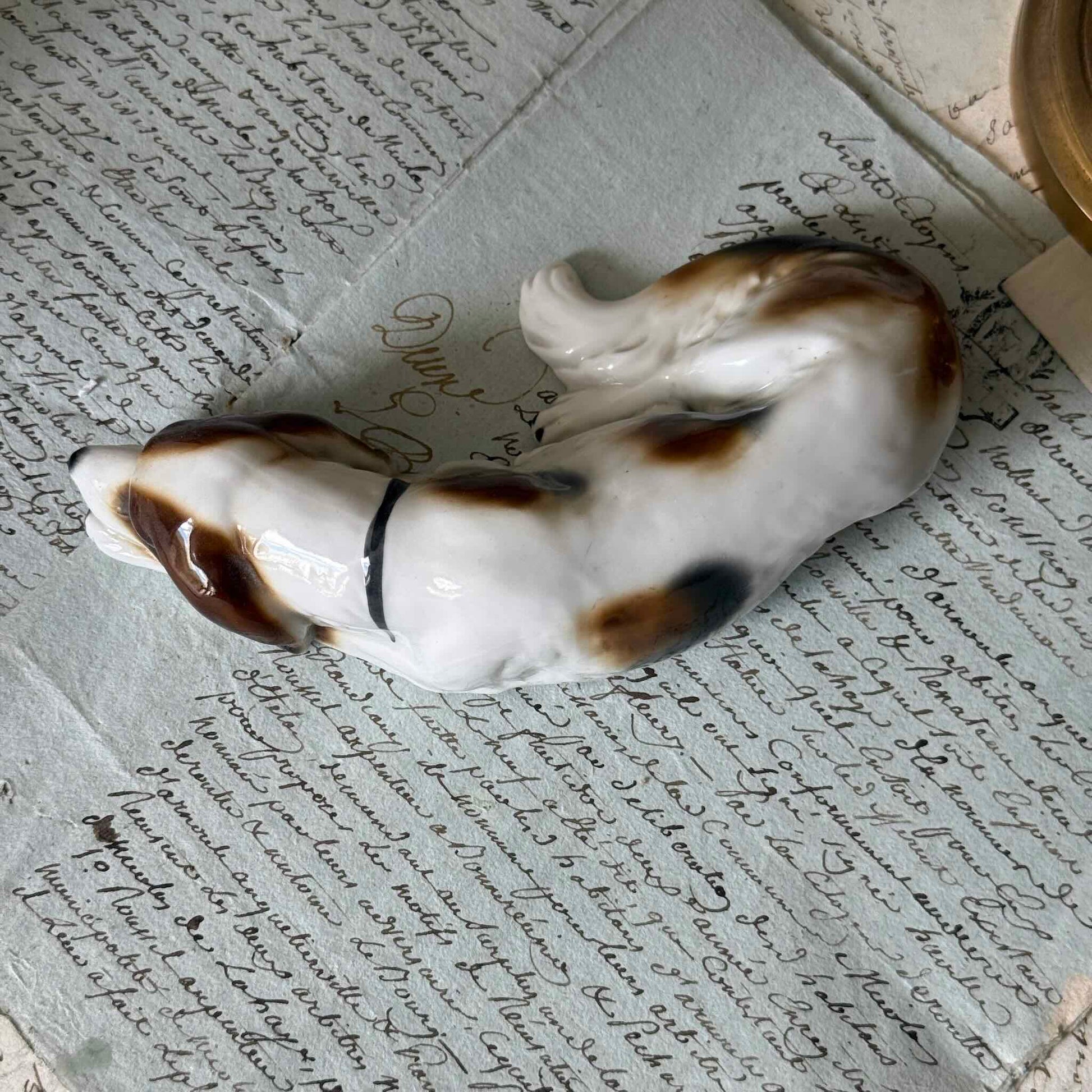 Vintage Goebel porcelain figurine of a sleeping hunting dog, hand-painted brown and white coat, circa 1935 Germany.