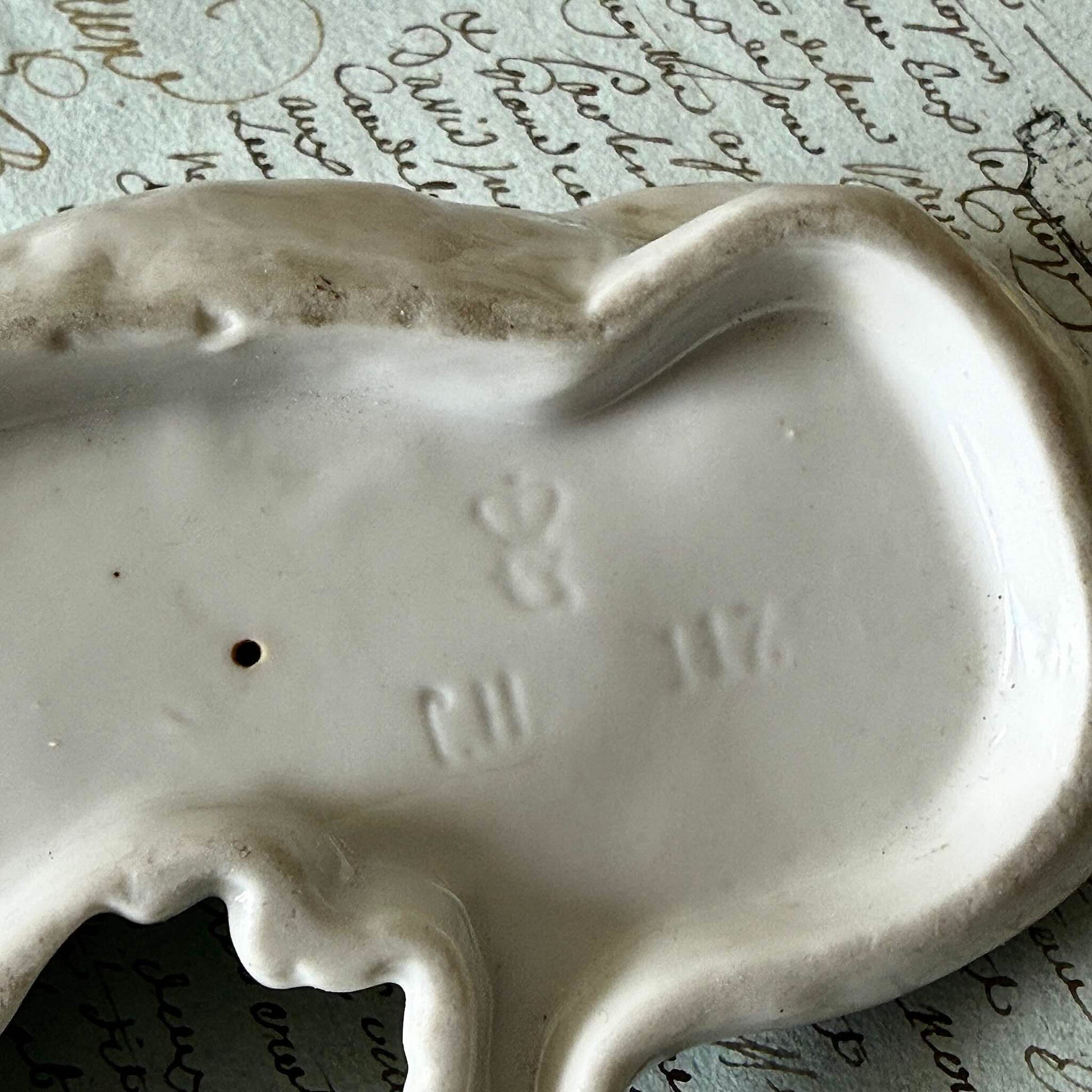 Vintage Goebel porcelain figurine of a sleeping hunting dog, hand-painted brown and white coat, circa 1935 Germany.
