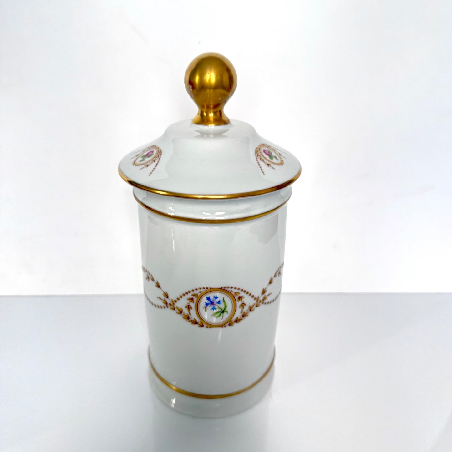 Vintage Limoges Castel porcelain apothecary jar with lid, decorated with floral medallions and gold scrolls, France.