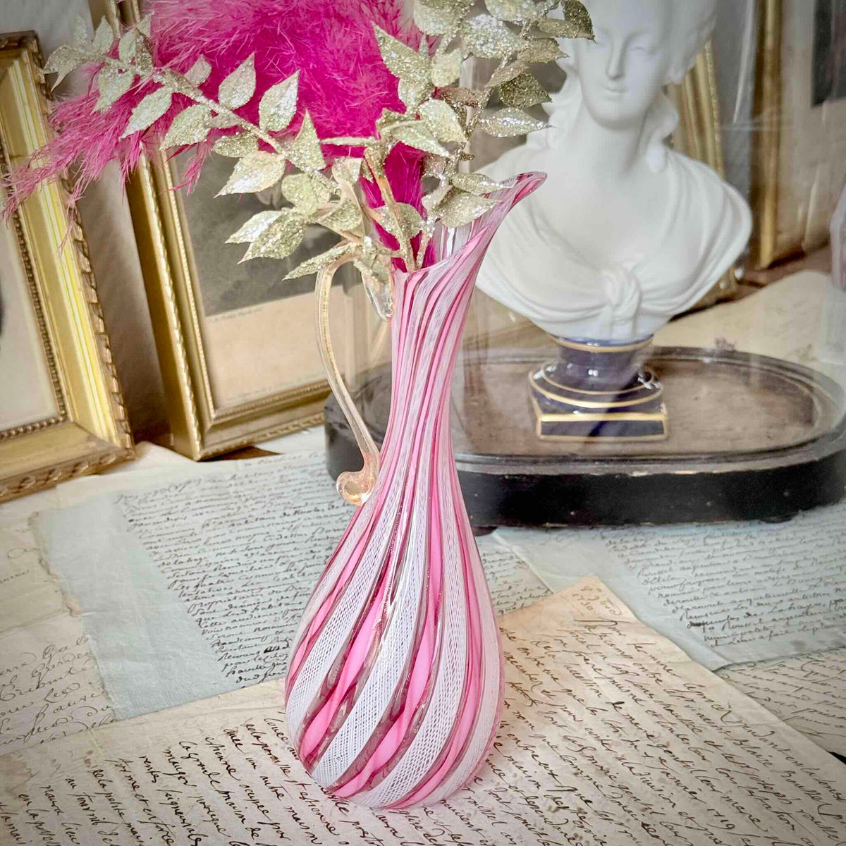 Vintage Murano glass ewer vase featuring pink and white latticino filigree patterns, mid-20th century Italy.