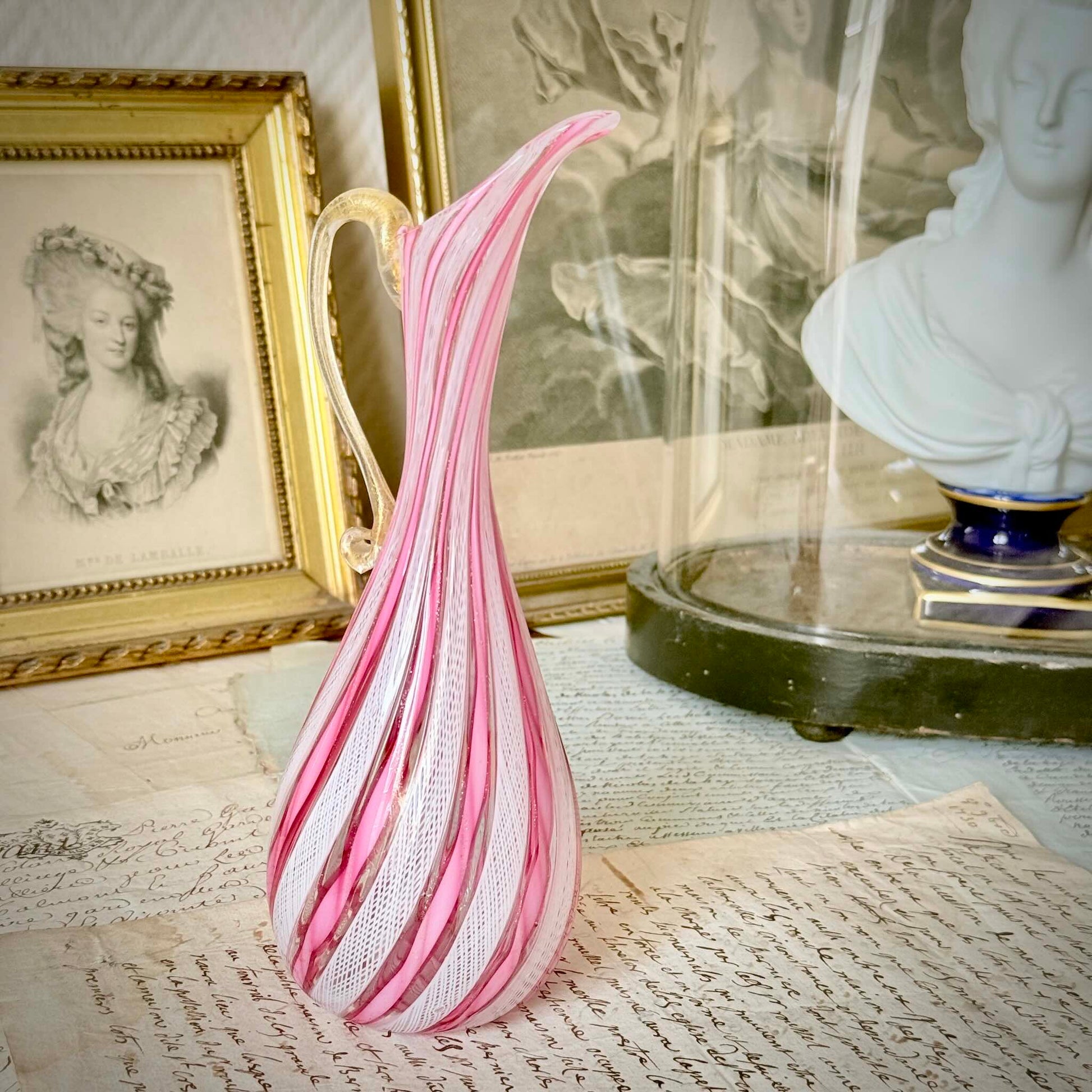 Vintage Murano glass ewer vase featuring pink and white latticino filigree patterns, mid-20th century Italy.
