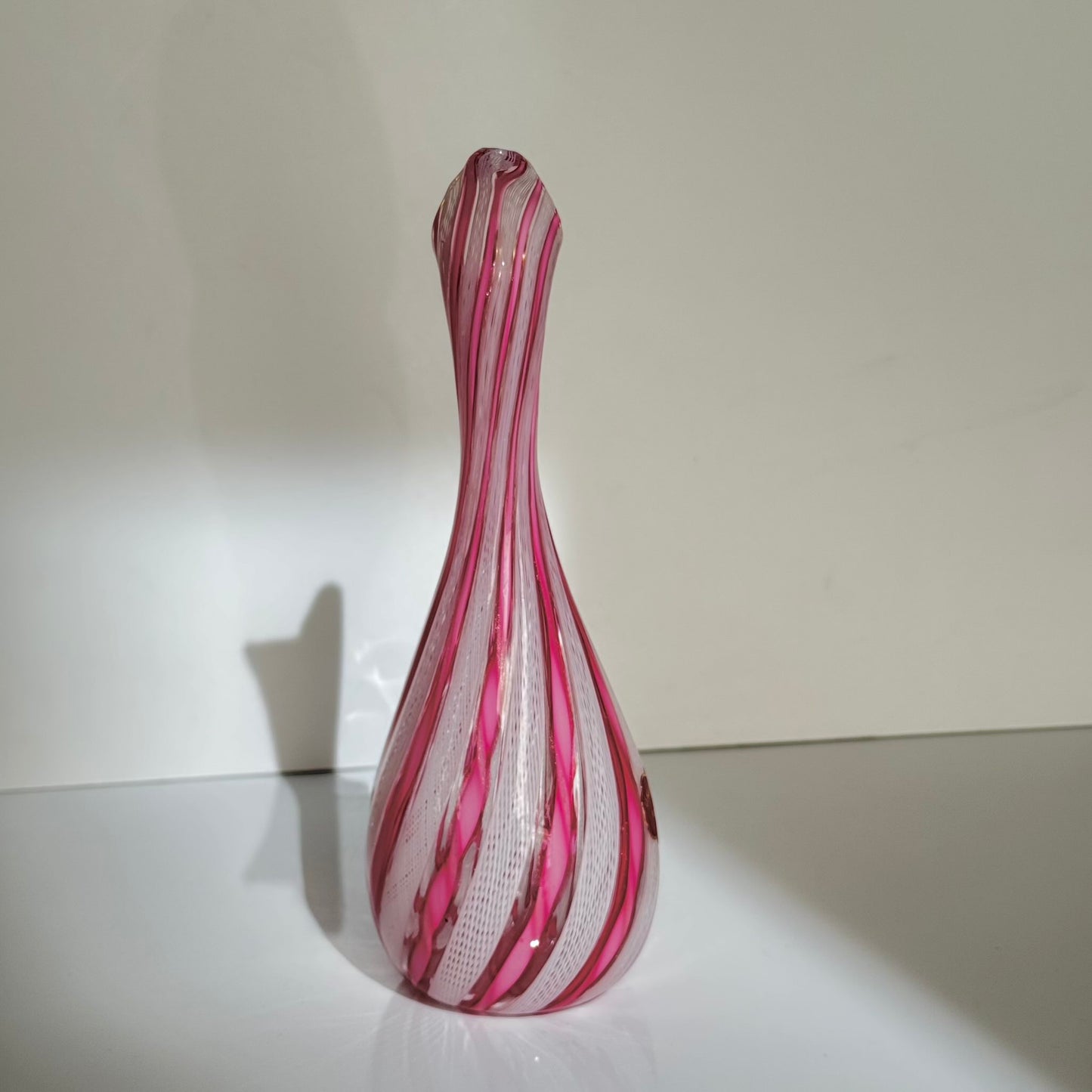 Vintage Murano glass ewer vase featuring pink and white latticino filigree patterns, mid-20th century Italy.