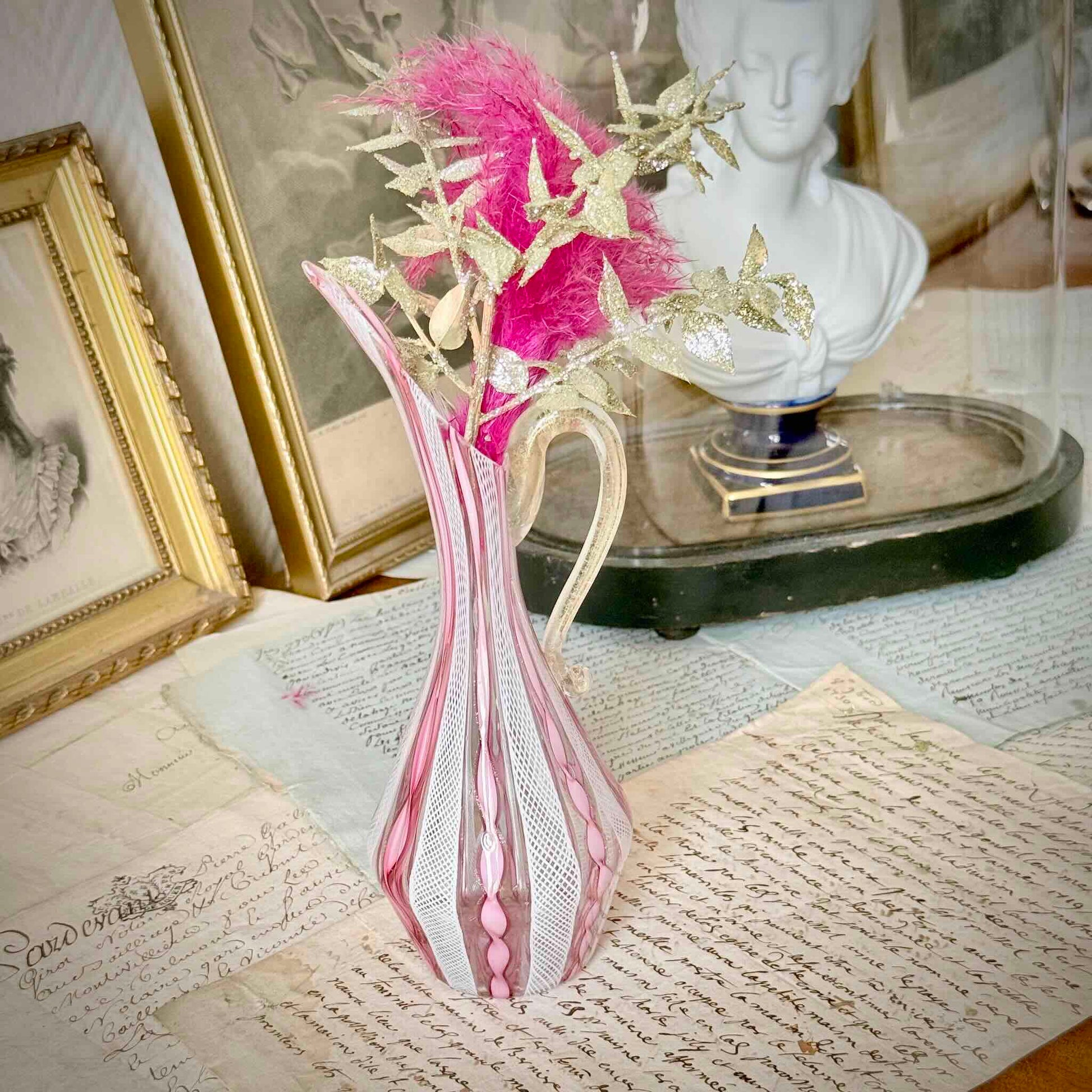 Vintage Murano glass ewer vase featuring pink and white latticino filigree patterns, mid-20th century Italy.