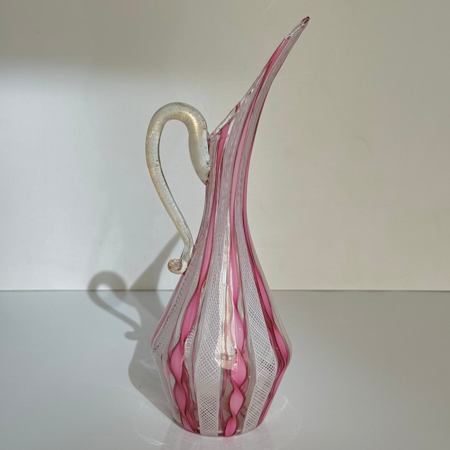 Vintage Murano glass ewer vase featuring pink and white latticino filigree patterns, mid-20th century Italy.