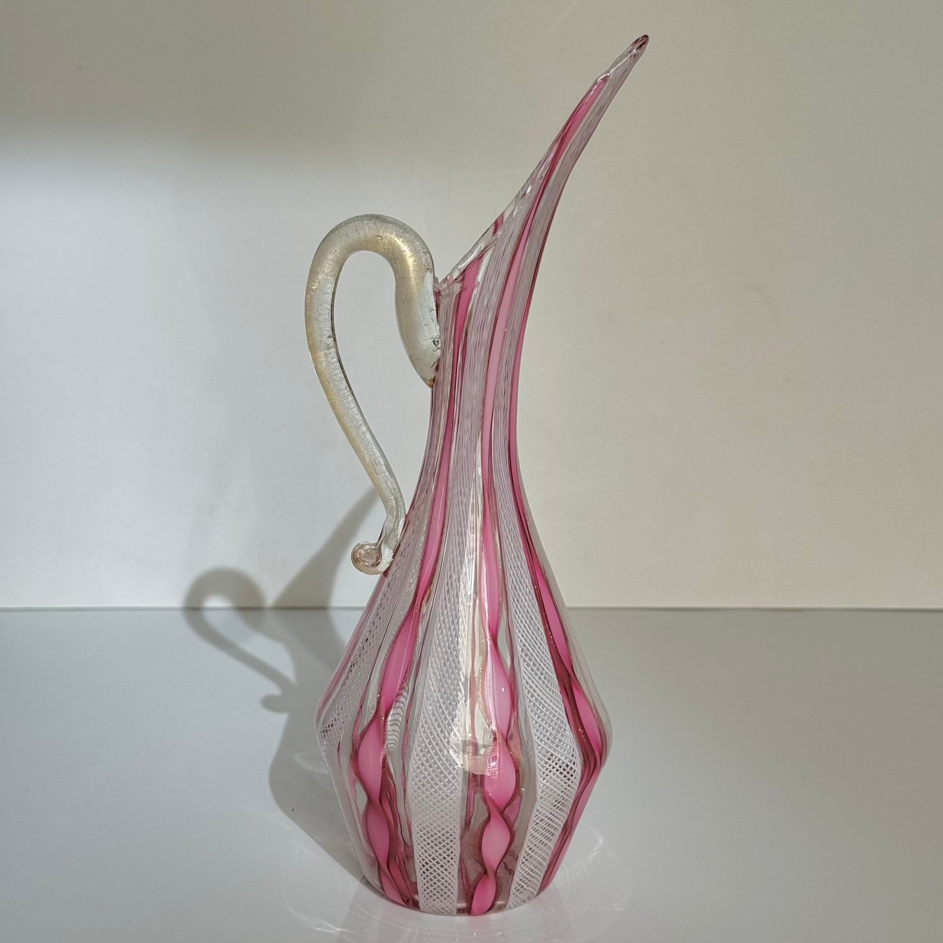 Vintage Murano glass ewer vase featuring pink and white latticino filigree patterns, mid-20th century Italy.