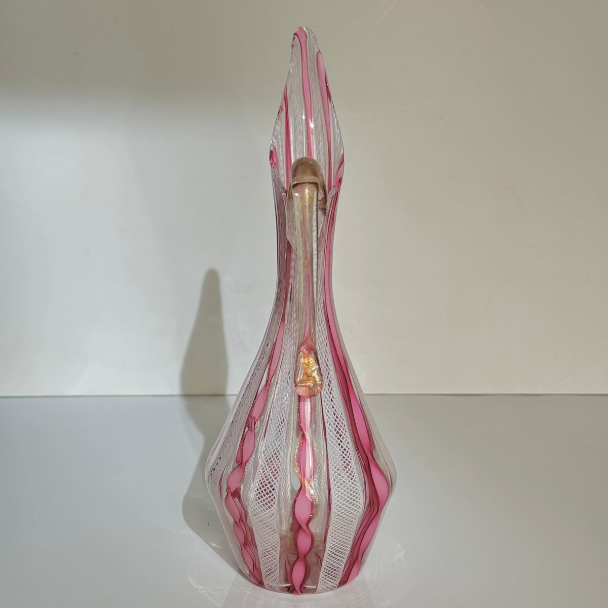 Vintage Murano glass ewer vase featuring pink and white latticino filigree patterns, mid-20th century Italy.