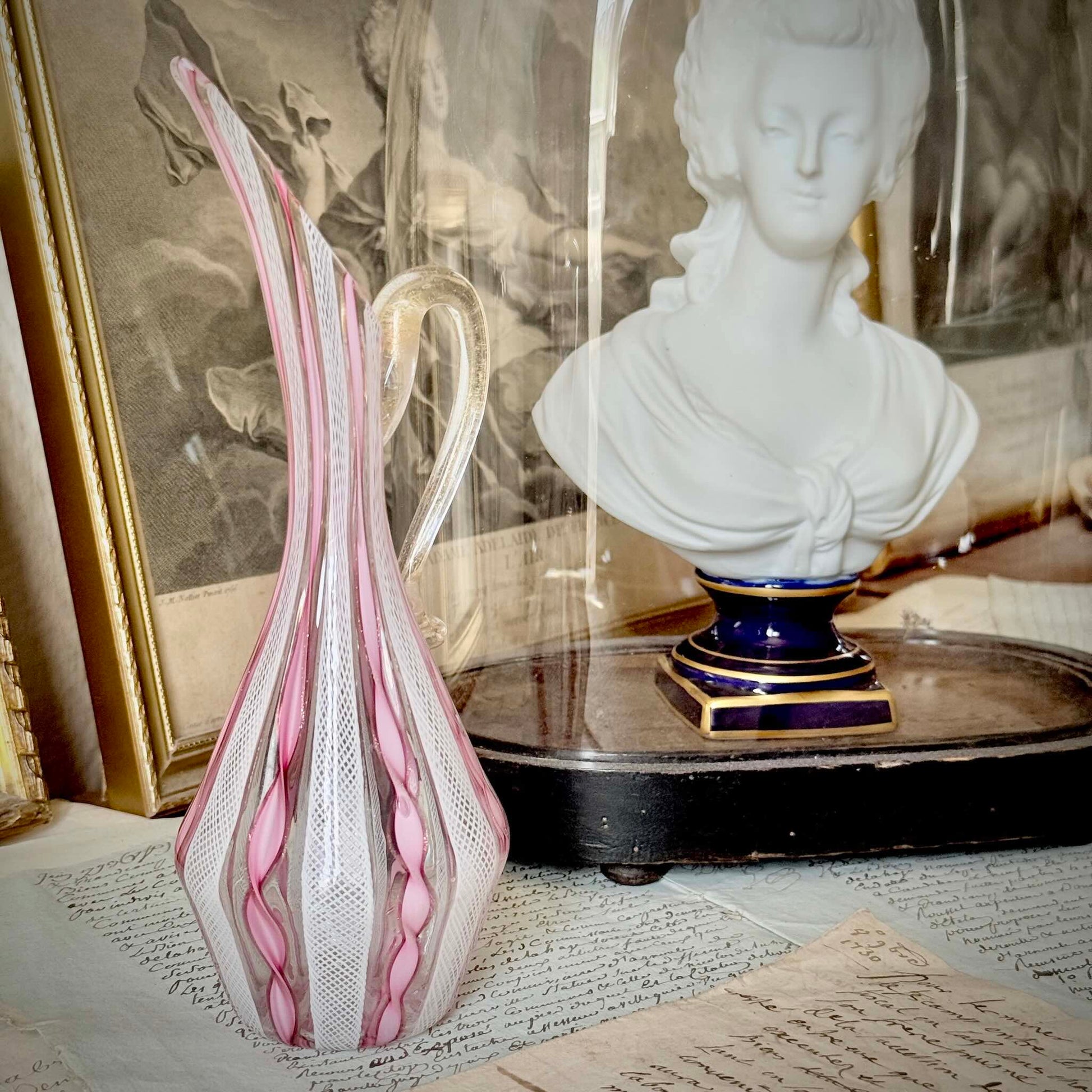 Vintage Murano glass ewer vase featuring pink and white latticino filigree patterns, mid-20th century Italy.
