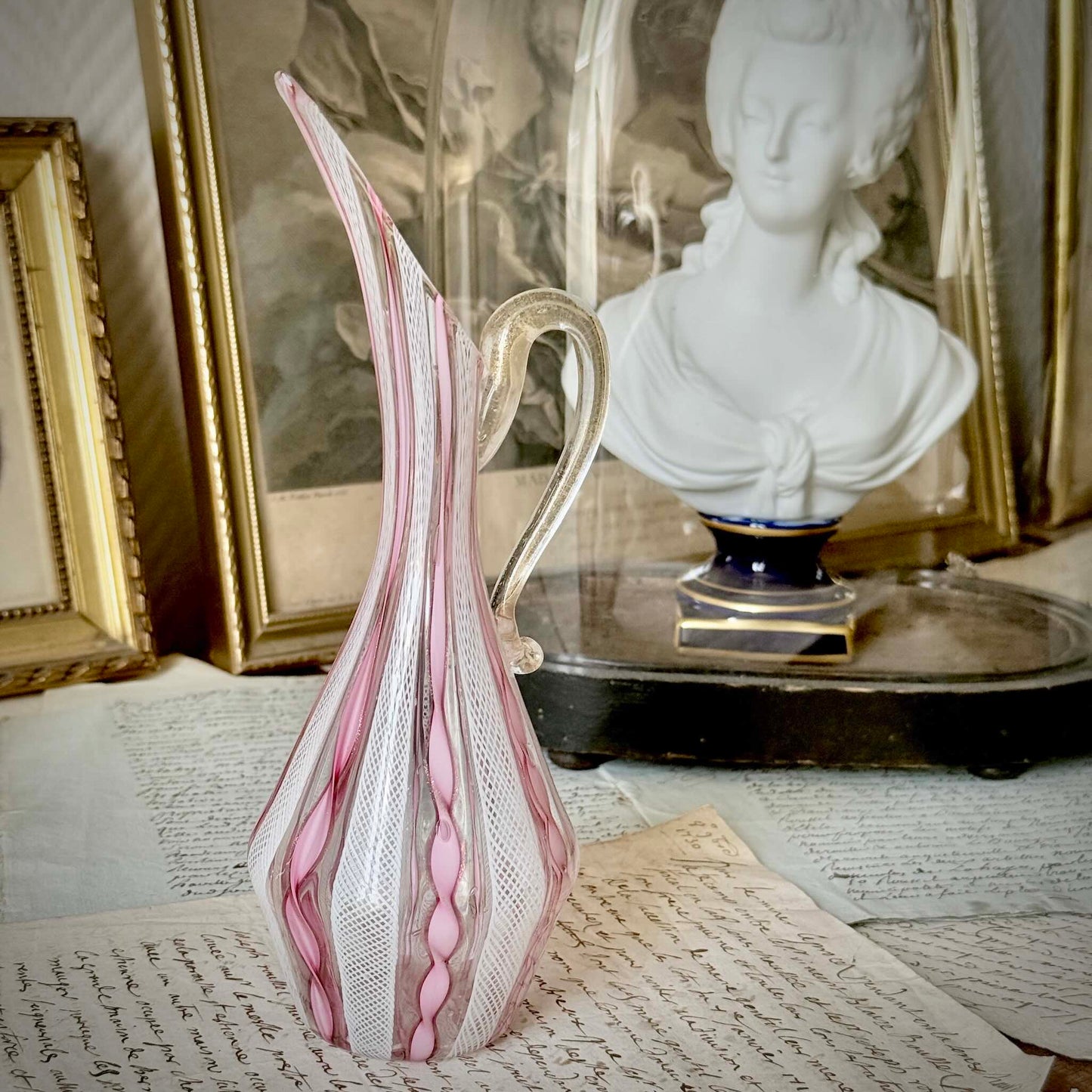 Vintage Murano glass ewer vase featuring pink and white latticino filigree patterns, mid-20th century Italy.