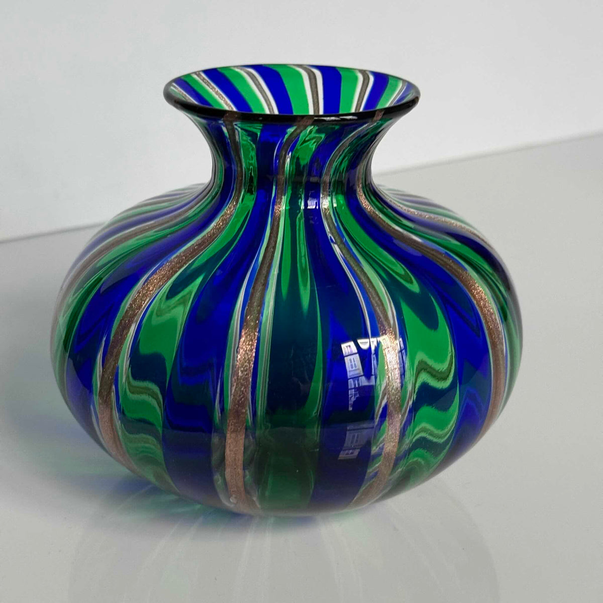 Vintage Murano blown glass vase attributed to Livio Campanella, featuring emerald green, blue, and fine gold flakes.